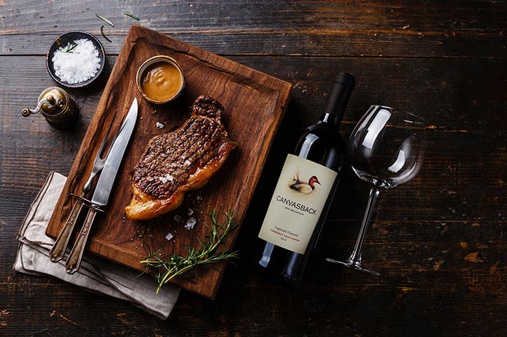 A steak with a Canvasback bottle