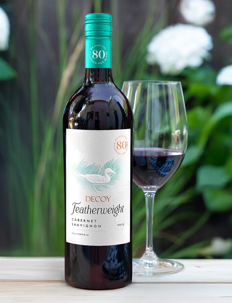 Decoy Featherweight California Chardonnay with vegetable dishes on a countertop