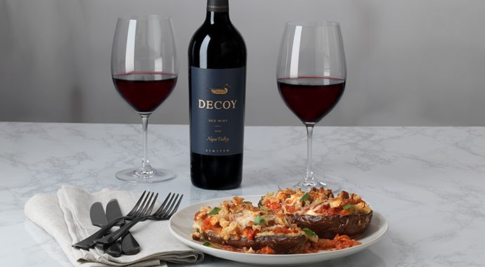 Deconstructed Eggplant Parmesan with wine on marble countertop