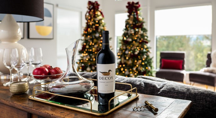 Wine on table with Christmas tree in background