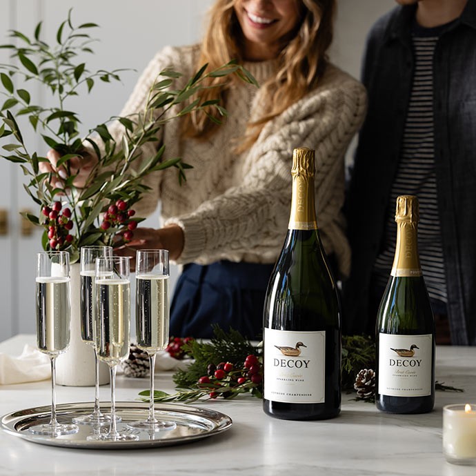 Decoy Sparkling Magnum and 750ml on a table with four glasses