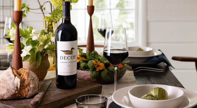 Decoy Cabernet on dining table with bread and glass of wine