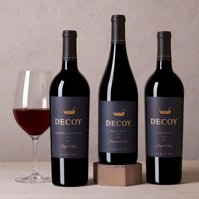 Three bottles of Decoy Limited with a glass of wine