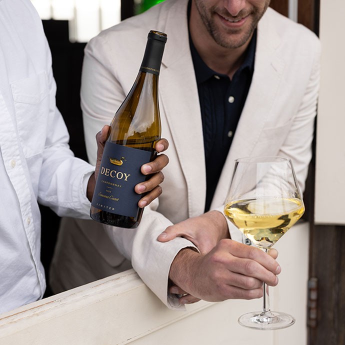 Decoy Limited Chardonnay being enjoyed by two males