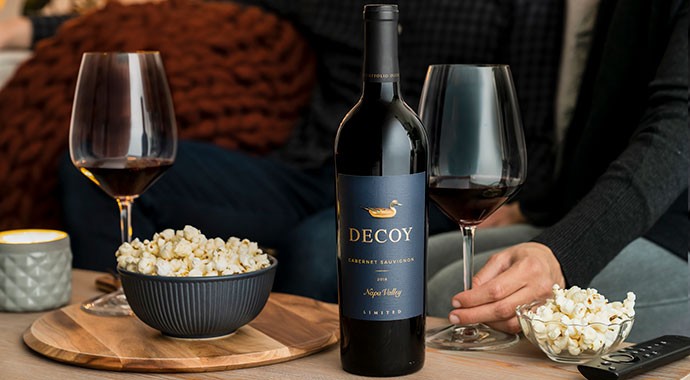 Decoy Limited Cabernet with popcorn and two wine glasses