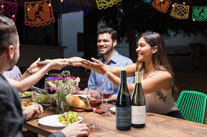 People enjoying Migration wines at the Harvest Dinner