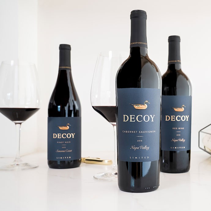 Three bottles of Decoy Limited wine bottles on white counter