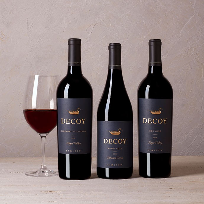 Three decoy limited wines with a glass of wine